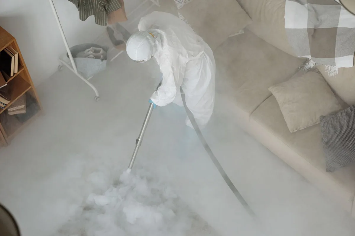 Biohazard cleanup technician in protective equipment, Bellevue, OH